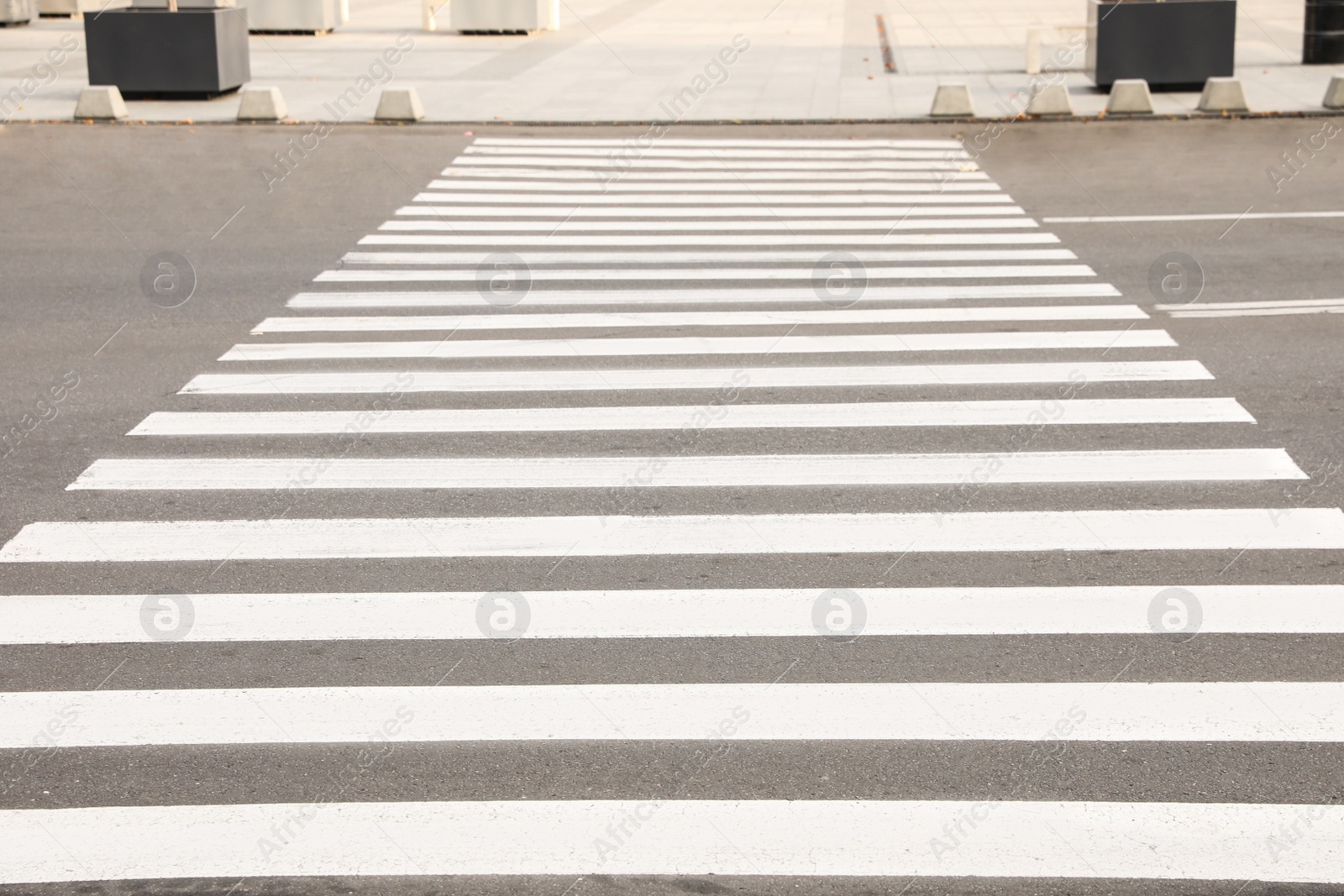 Photo of White pedestrian crossing on empty city street