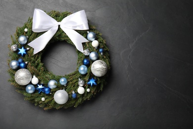 Beautiful Christmas wreath on black background, top view. Space for text