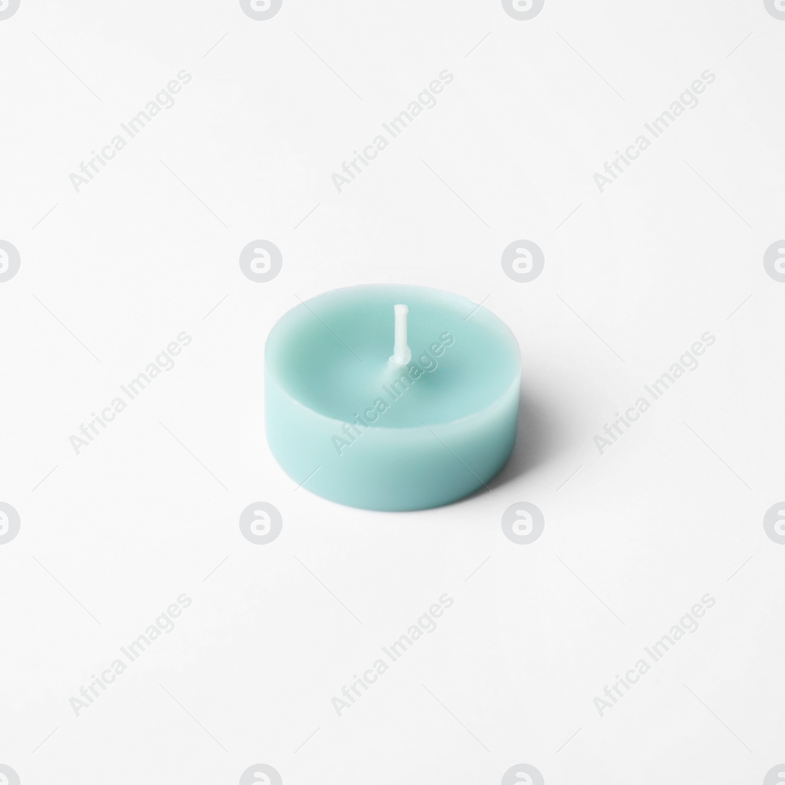 Photo of Light blue wax decorative candle isolated on white