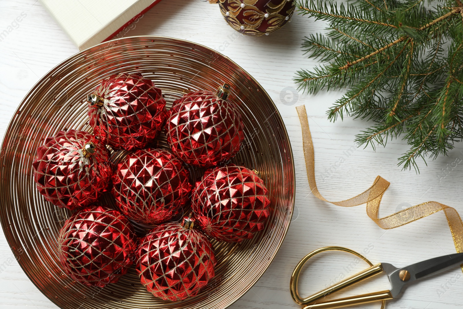 Photo of Flat lay composition with beautiful Christmas baubles on white wooden table