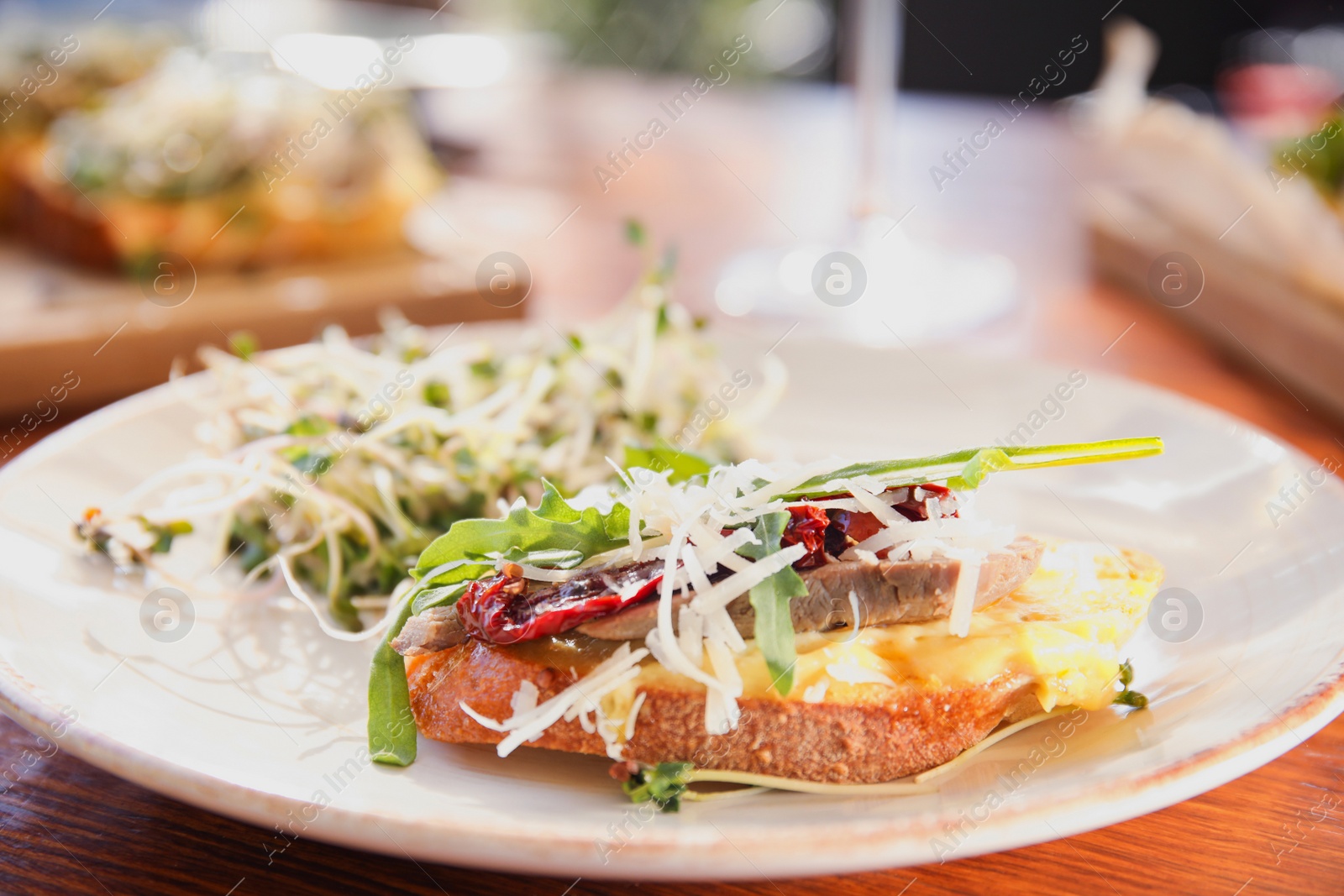 Photo of Delicious bruschettas served on wooden table, closeup