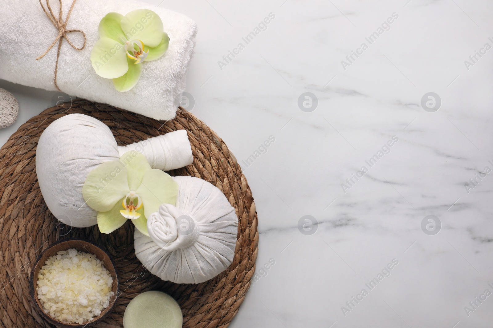 Photo of Flat lay composition with spa products and beautiful flowers on white marble table. Space for text