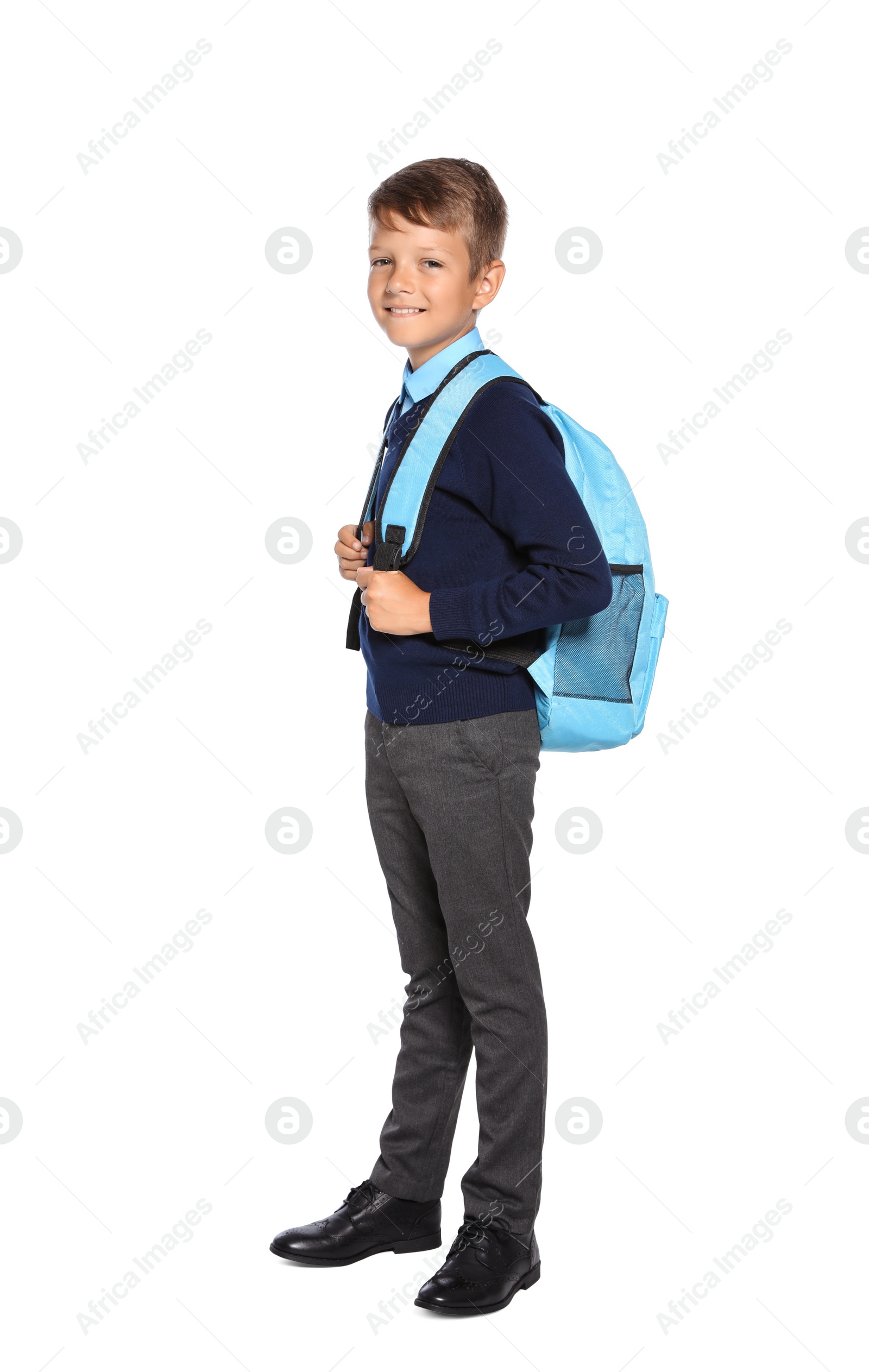 Photo of Little boy in stylish school uniform on white background