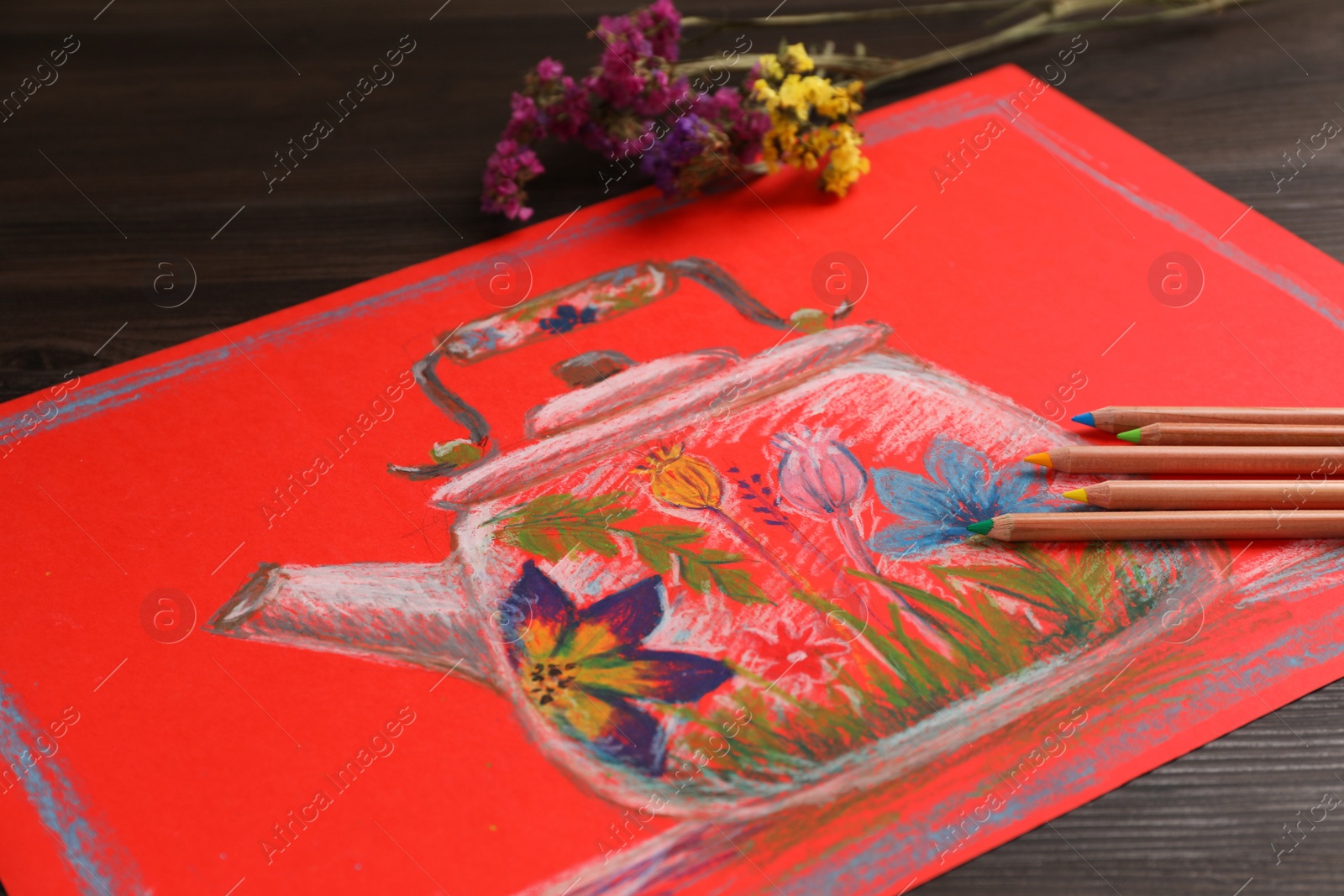 Photo of Colorful pastel pencils, flowers and beautiful painting on wooden table