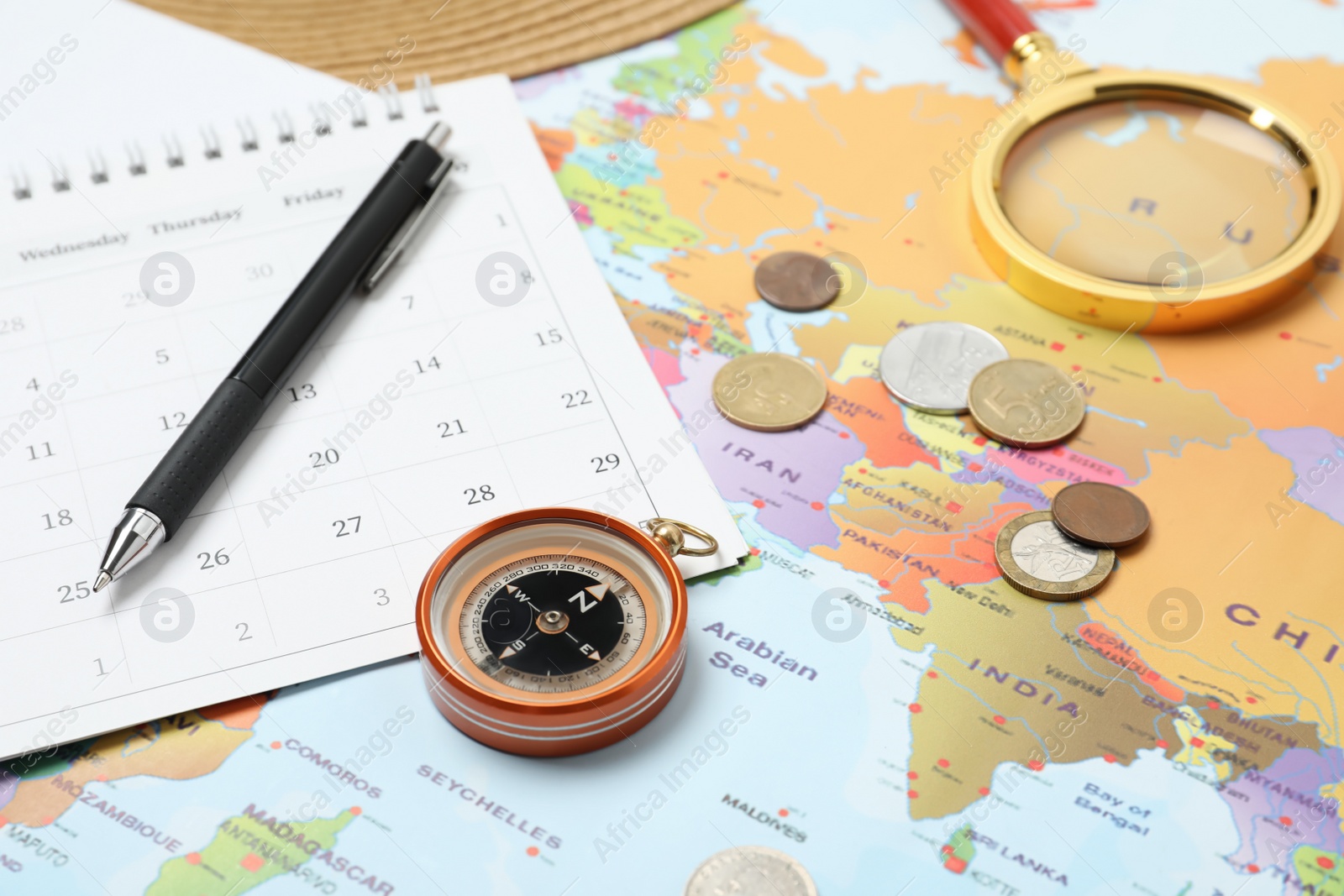 Photo of Different travel accessories on world map. Planning summer vacation trip