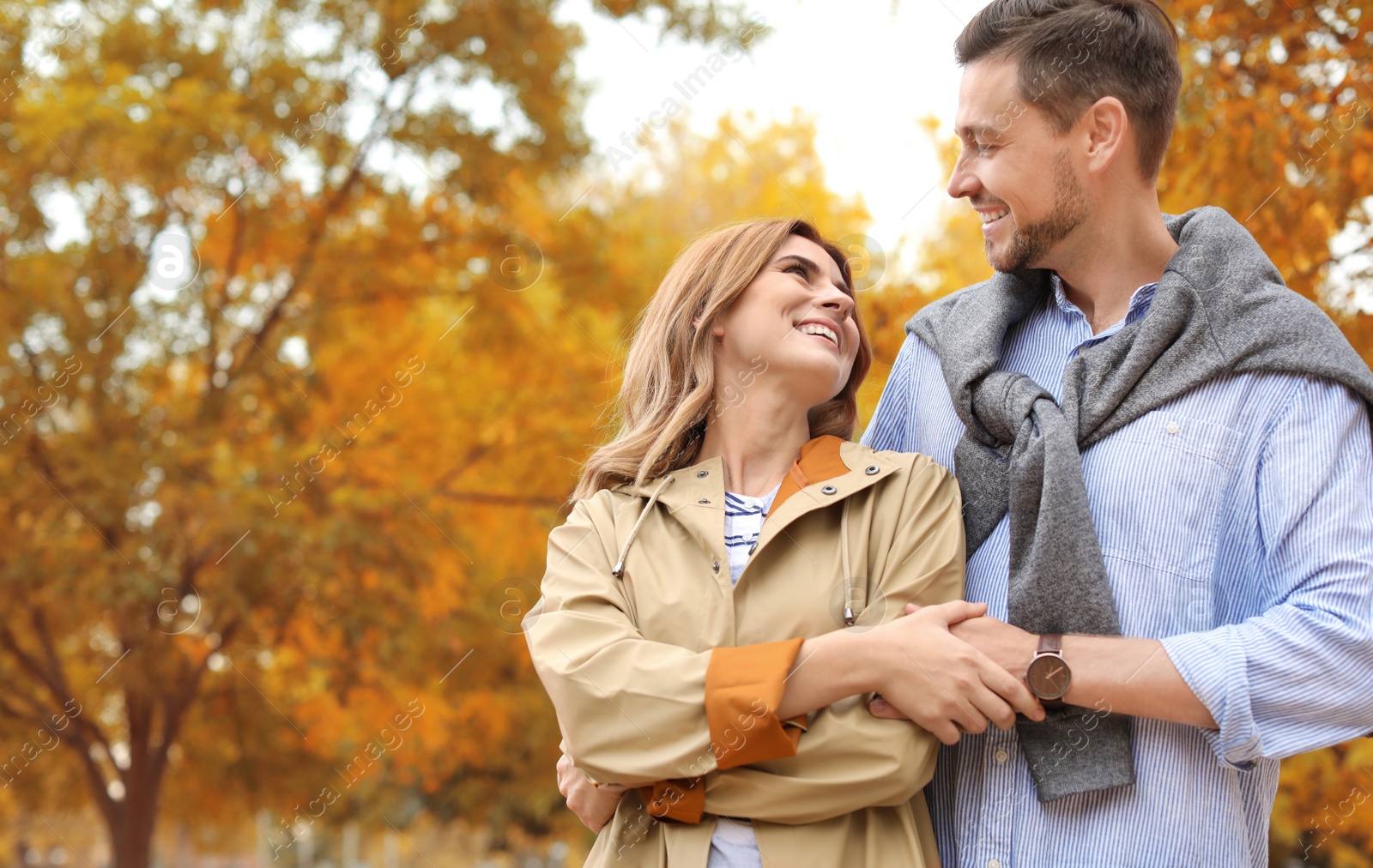 Photo of Lovely couple spending time together in park. Autumn walk