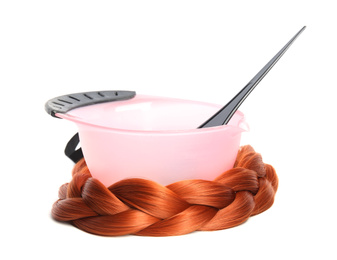 Photo of Bowl with dye and brush on white background