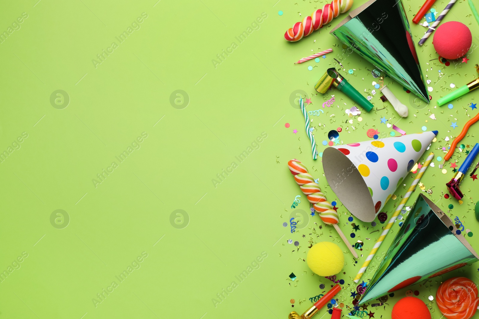 Photo of Beautiful flat lay composition with festive items on light green background, space for text. Surprise party concept