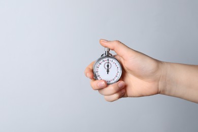 Woman holding vintage timer on white background, closeup. Space for text