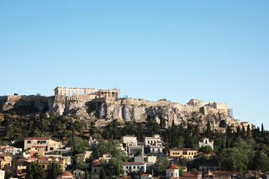 Picturesque view of cityscape with beautiful houses and acropolis on sunny day