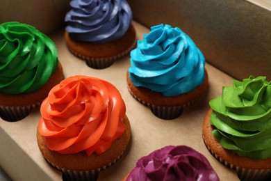 Photo of Different cupcakes with cream in box, closeup