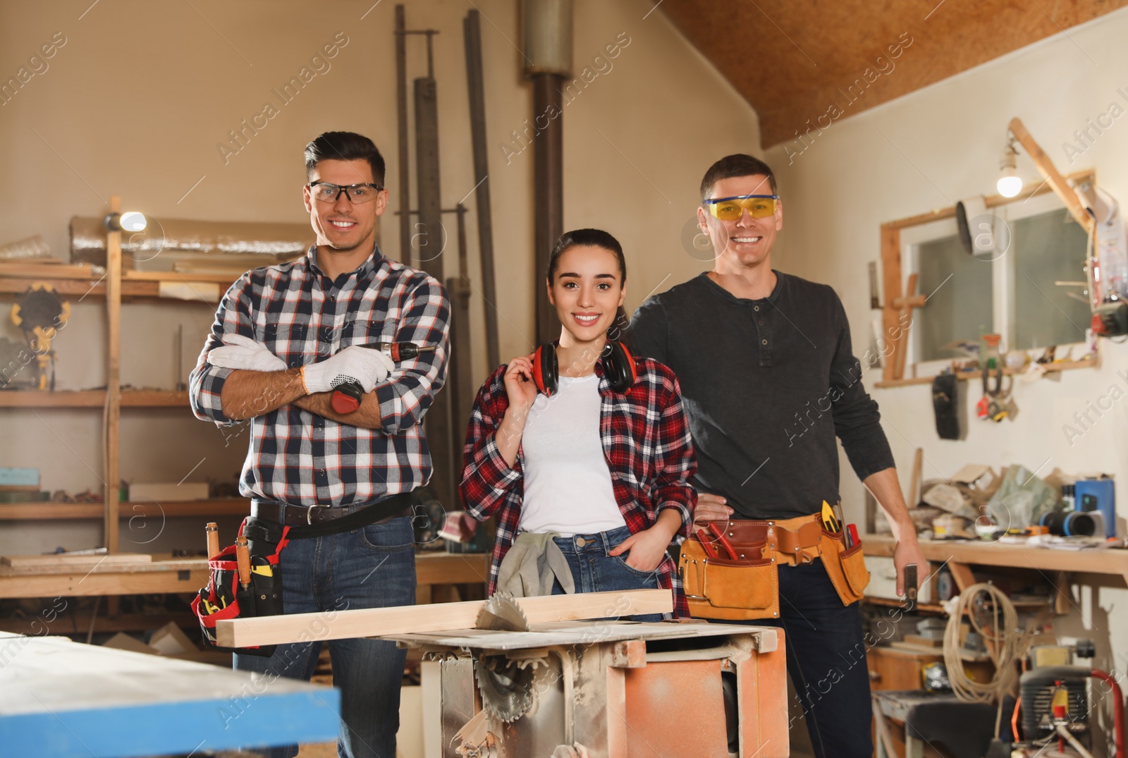 Photo of Team of professional carpenters in modern workshop