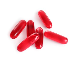 Photo of Many red pills isolated on white. Medicinal treatment