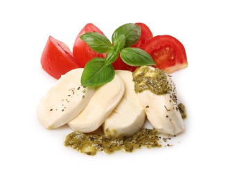 Photo of Tasty salad Caprese with mozzarella, tomatoes, basil and pesto sauce isolated on white