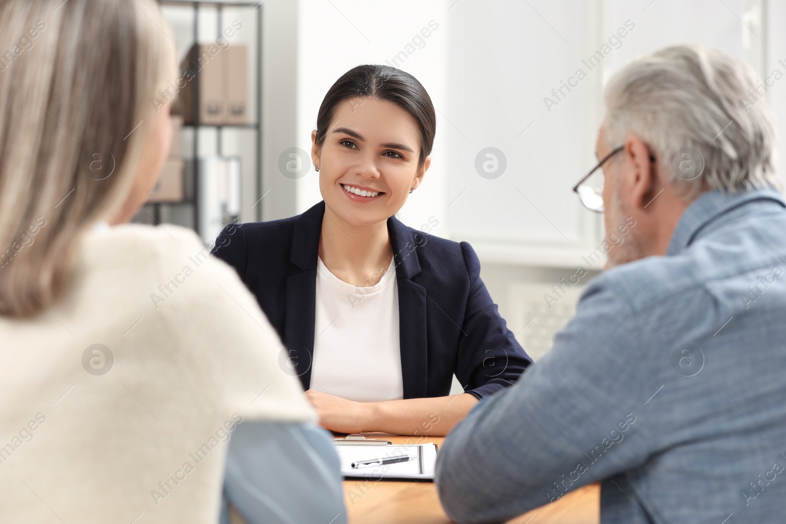 Photo of Notary consulting senior couple about Last Will and Testament in office