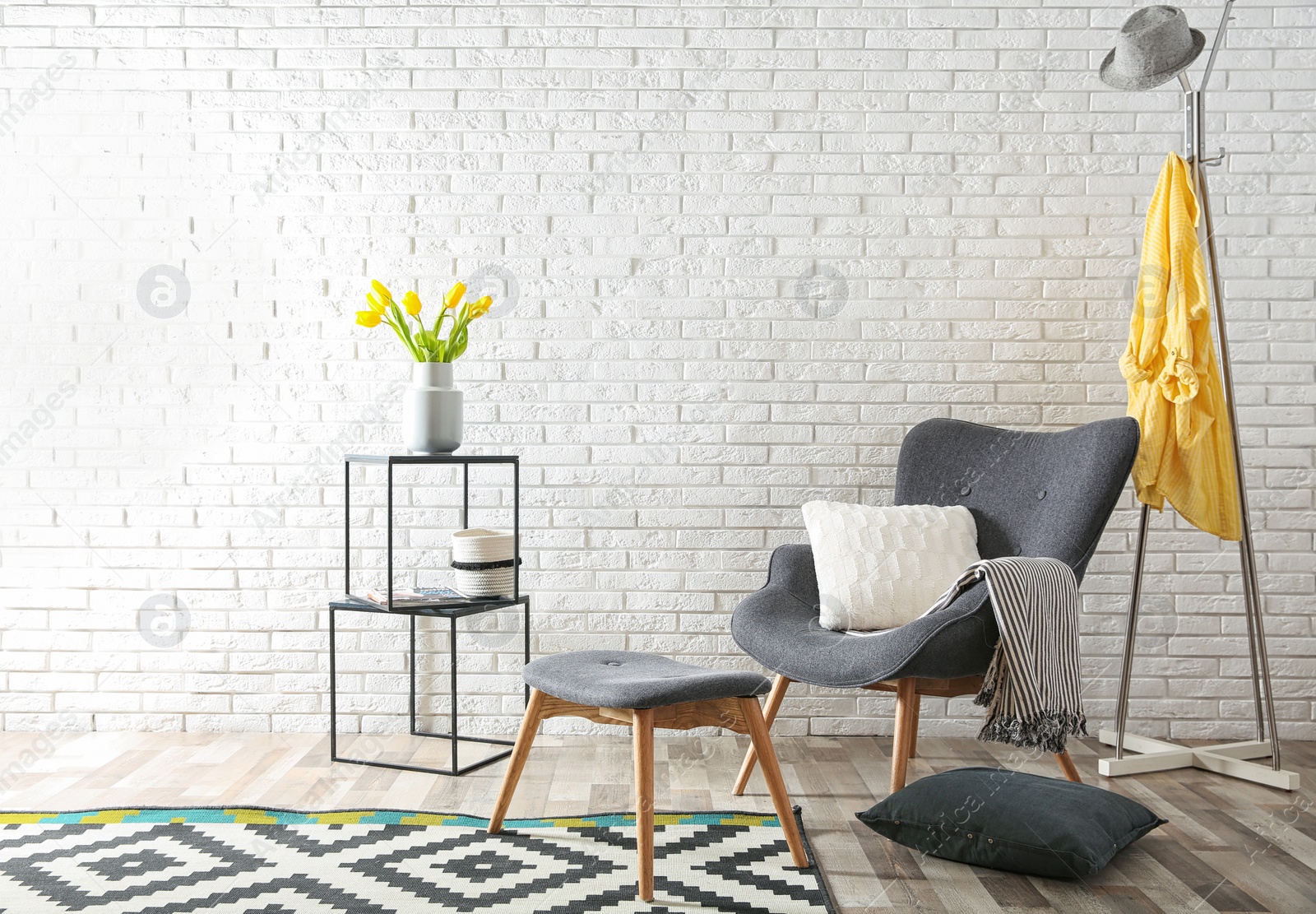 Photo of Modern living room interior with comfortable armchair near brick wall. Space for text