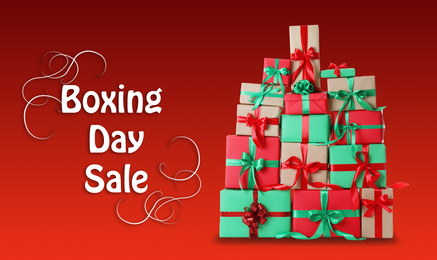 Image of Boxing day sale. Many different gifts on red background