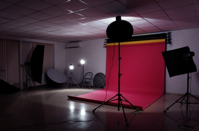 Photo of Interior of modern photo studio with professional lighting equipment