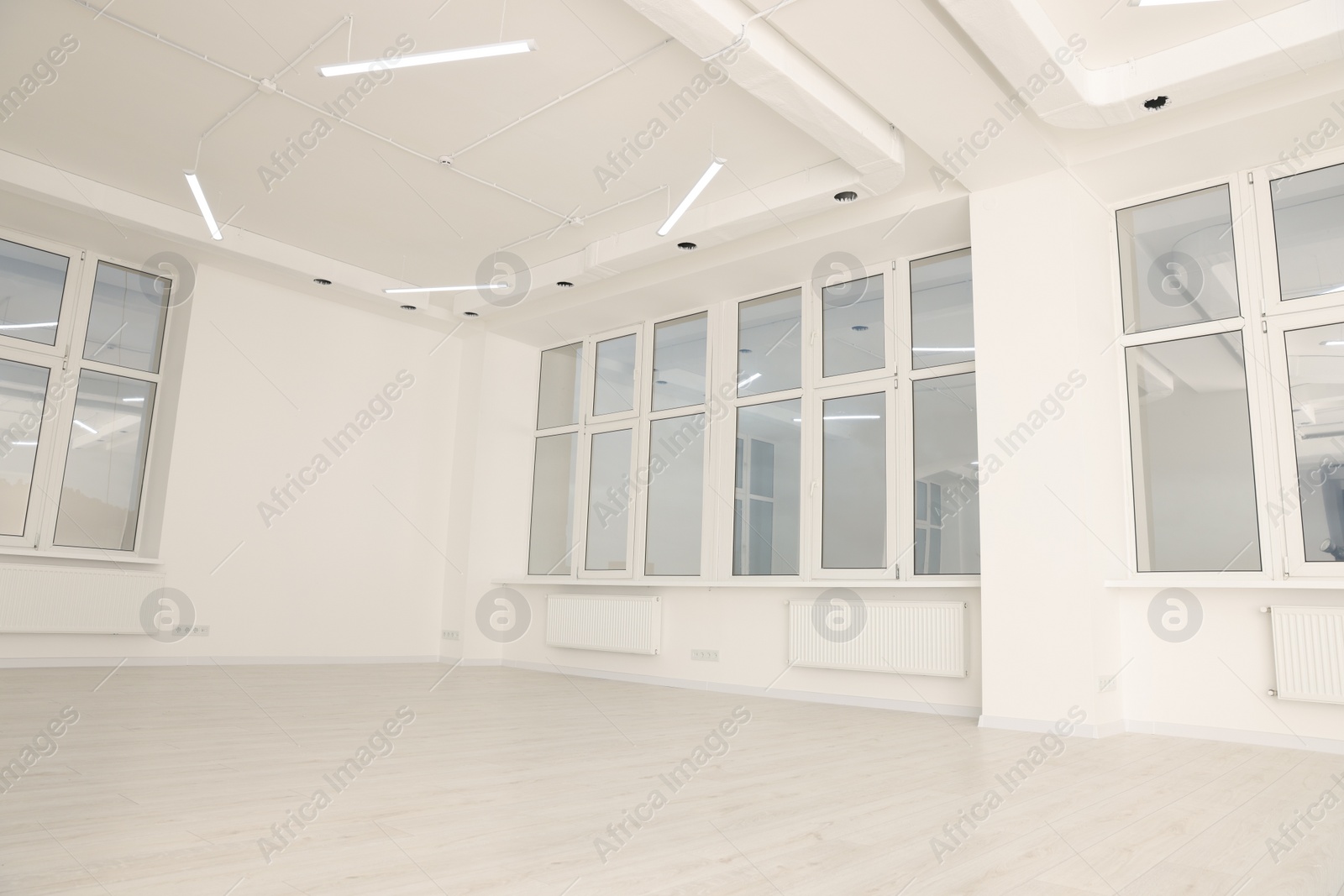 Photo of Modern office room with white walls and windows. Interior design