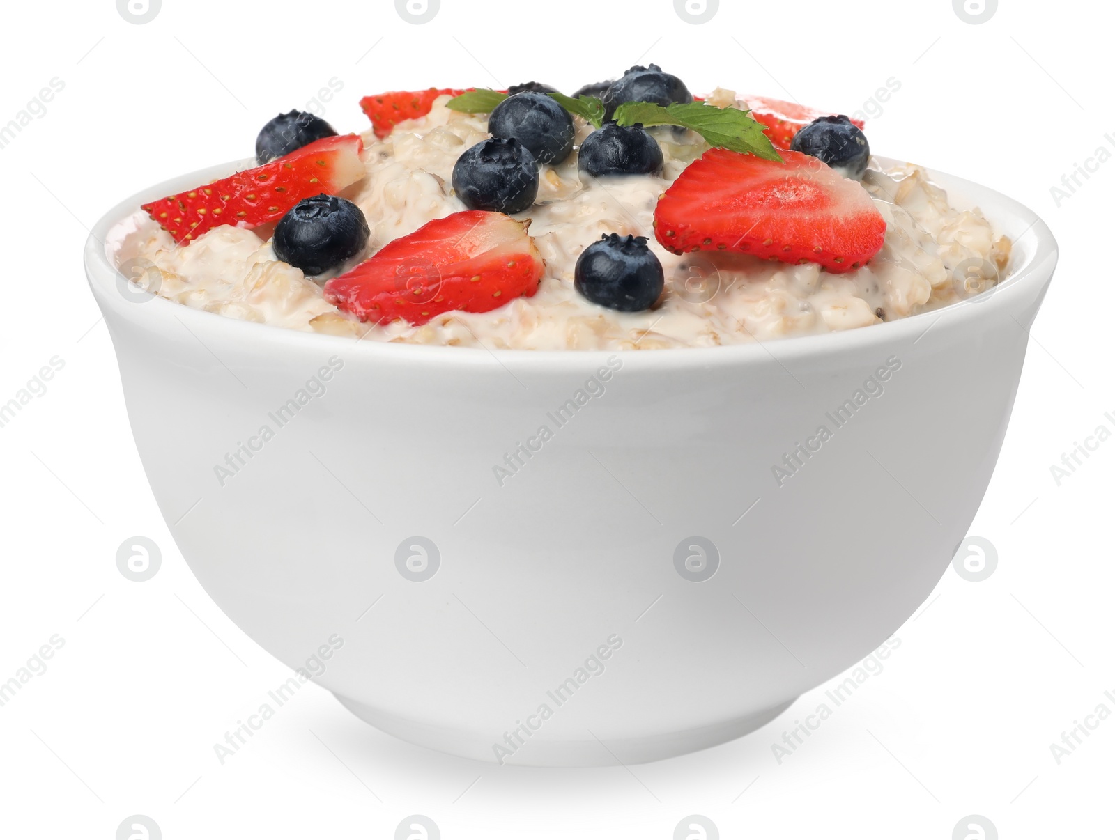 Photo of Tasty boiled oatmeal with berries in bowl isolated on white