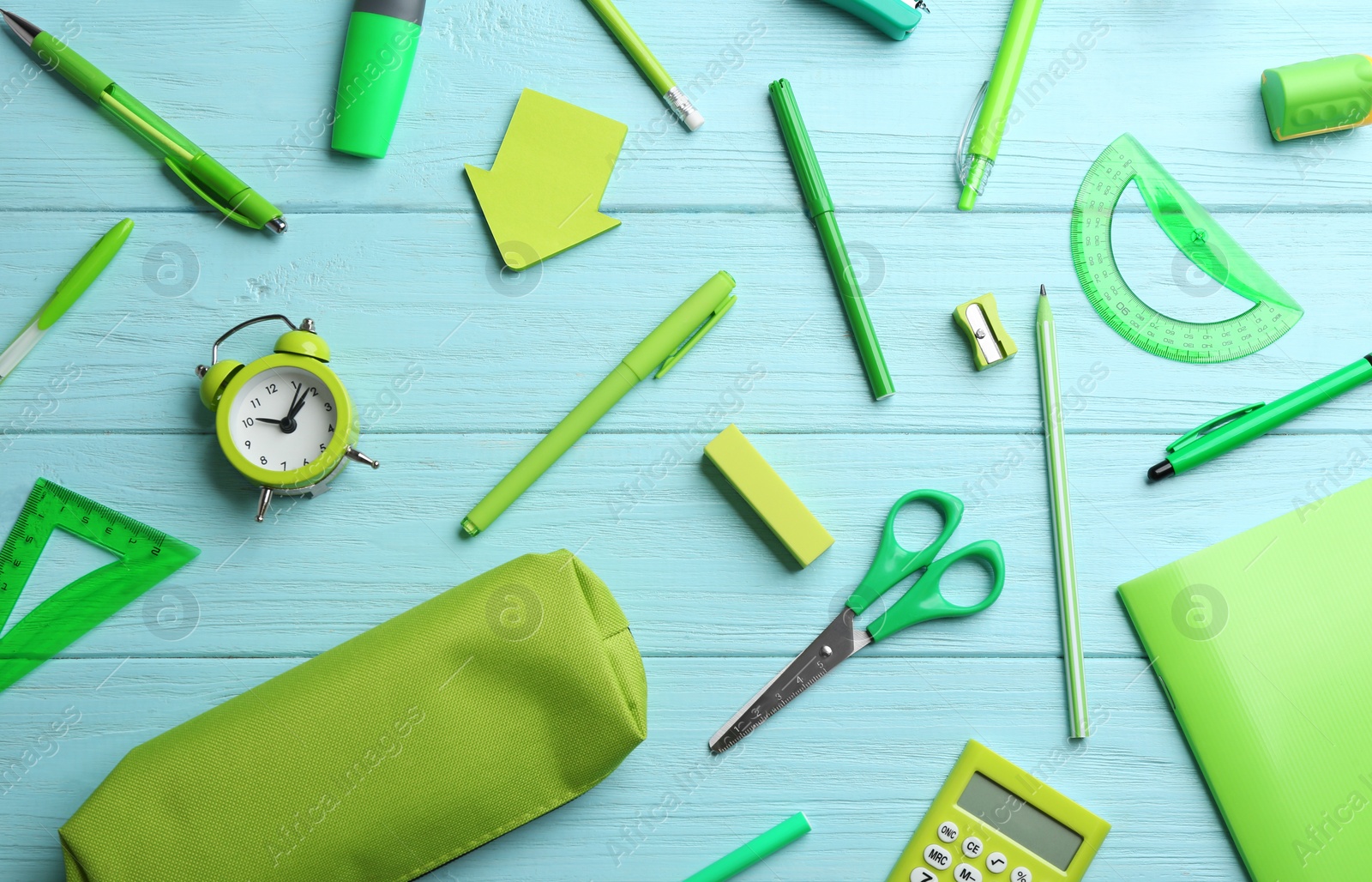 Photo of Different bright school stationery on light blue wooden background, flat lay