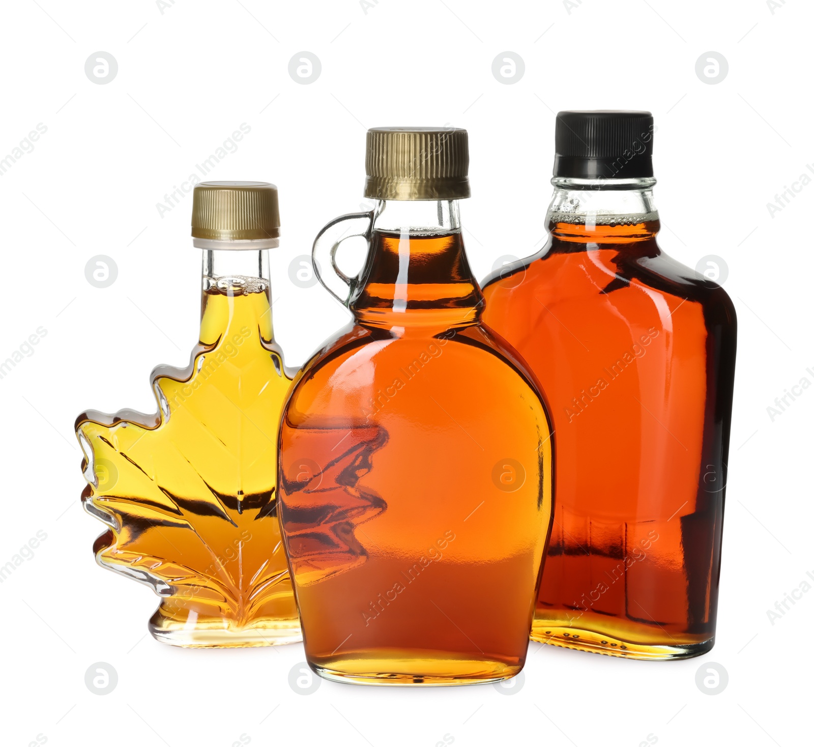 Photo of Different bottles of tasty maple syrup on white background