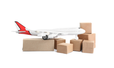 Photo of Airplane model and carton boxes on white background. Courier service