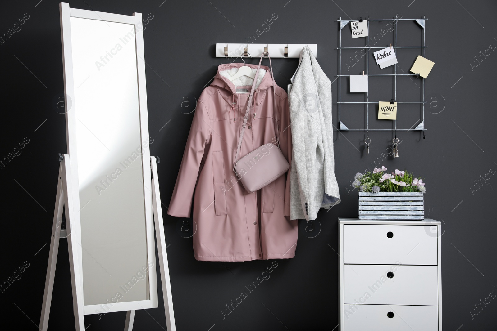 Photo of Hallway interior with stylish furniture, clothes and accessories
