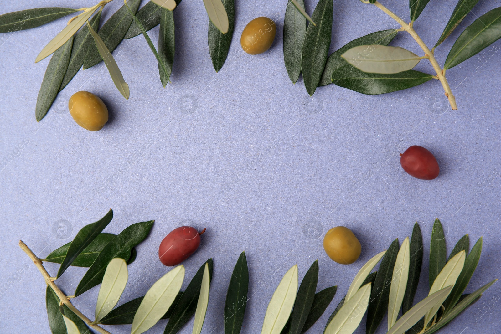 Photo of Different fresh olives and leaves on violet background, flat lay. Space for text