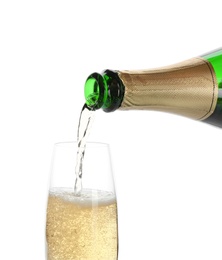 Pouring champagne from bottle into glass on white background. Festive drink