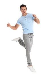 Handsome young man dancing on white background