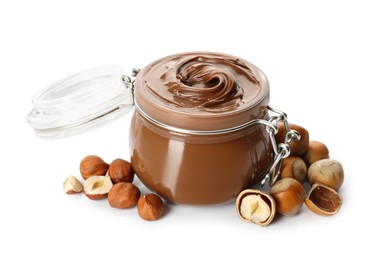 Photo of Glass jar with tasty chocolate hazelnut spread and nuts on white background