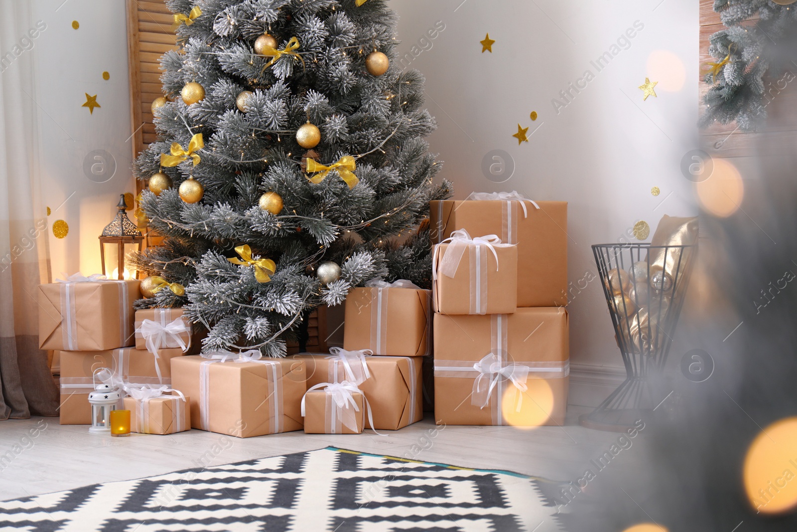 Photo of Stylish room interior with beautiful Christmas tree and gift boxes