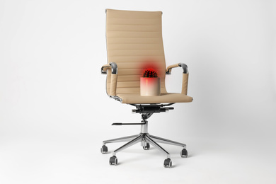 Hemorrhoid concept. Office chair with cactus isolated on white