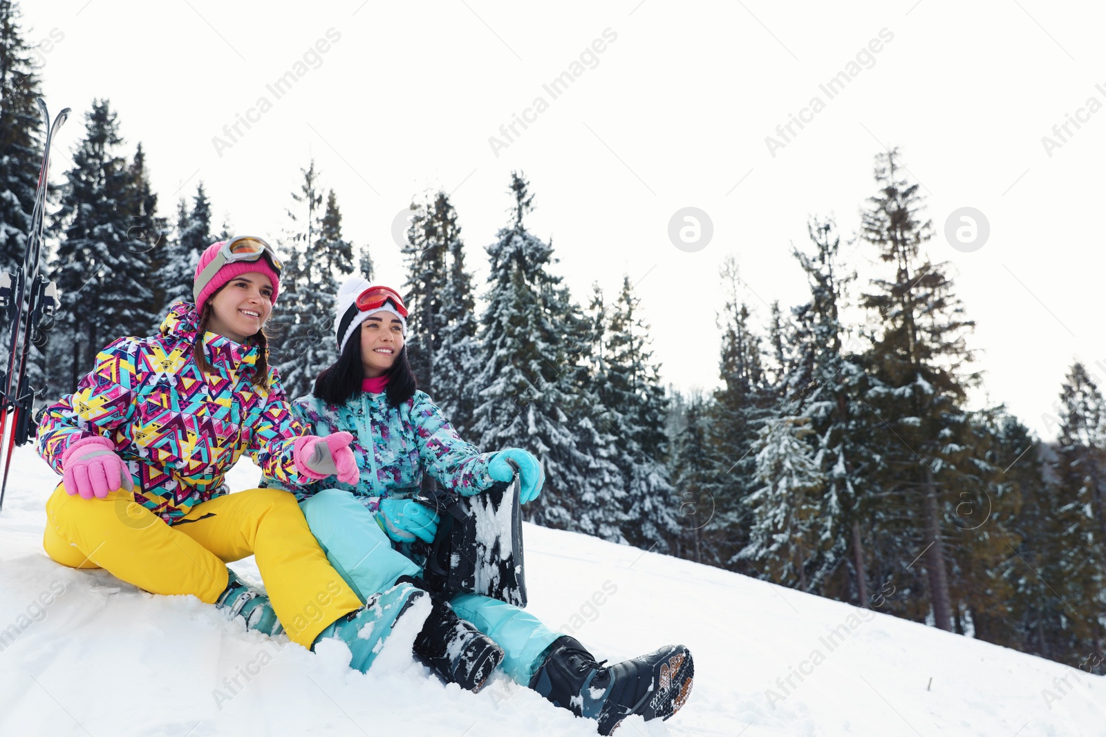 Photo of Friends with equipment on snowy hill. Winter vacation