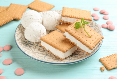 Sweet delicious ice cream cookie sandwiches on light blue wooden table