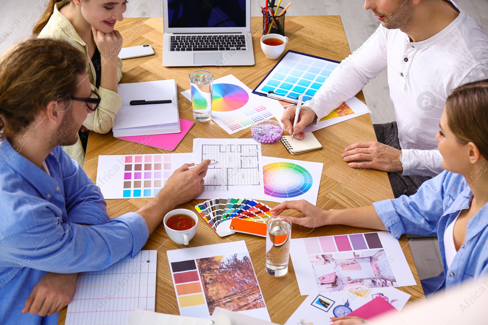 Photo of Professional team of interior designers working at table