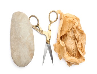 Photo of Rock, crumpled paper and scissors on white background, top view