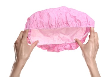 Photo of Woman holding pink shower cap on white background, closeup