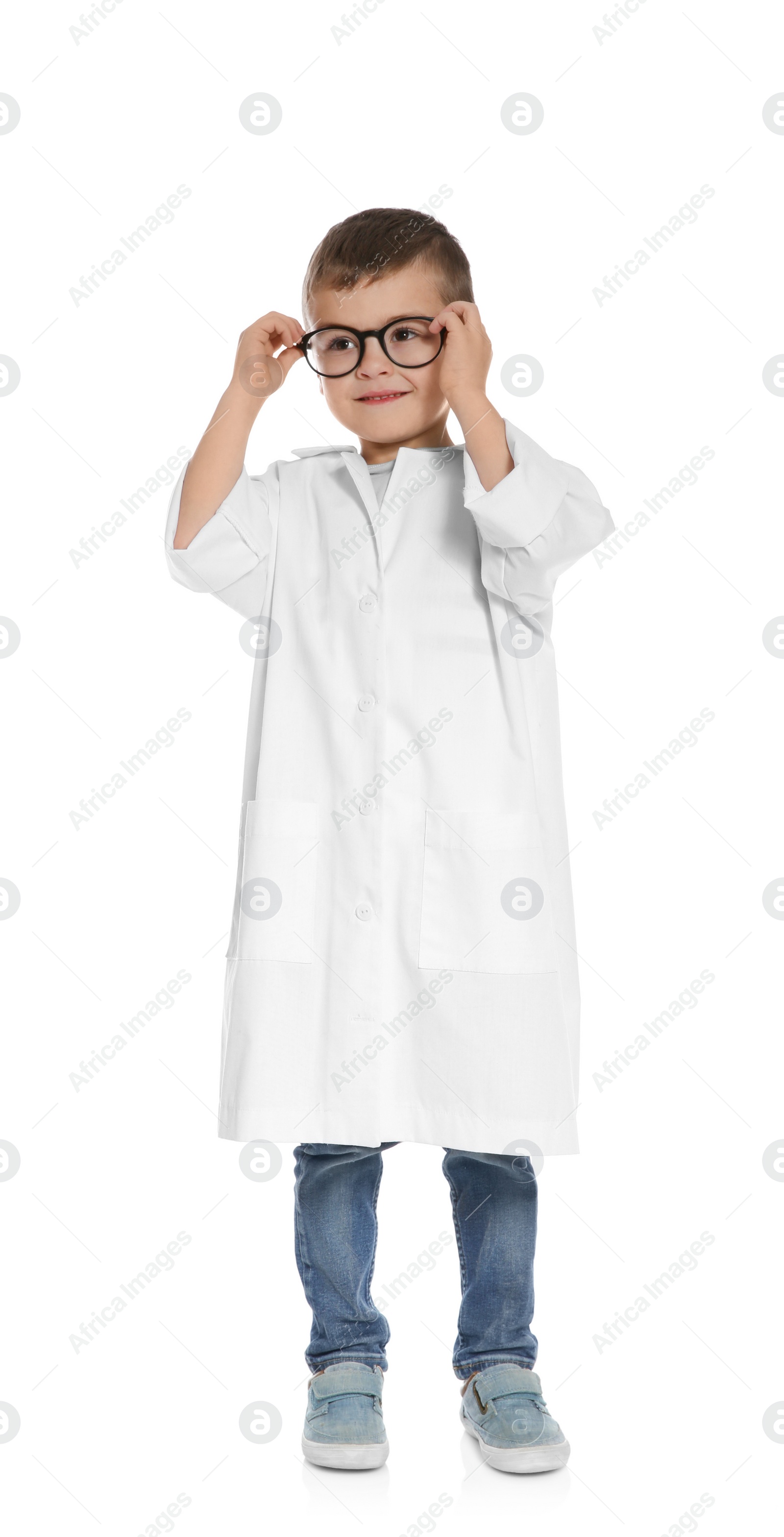 Photo of Cute little child in doctor coat on white background