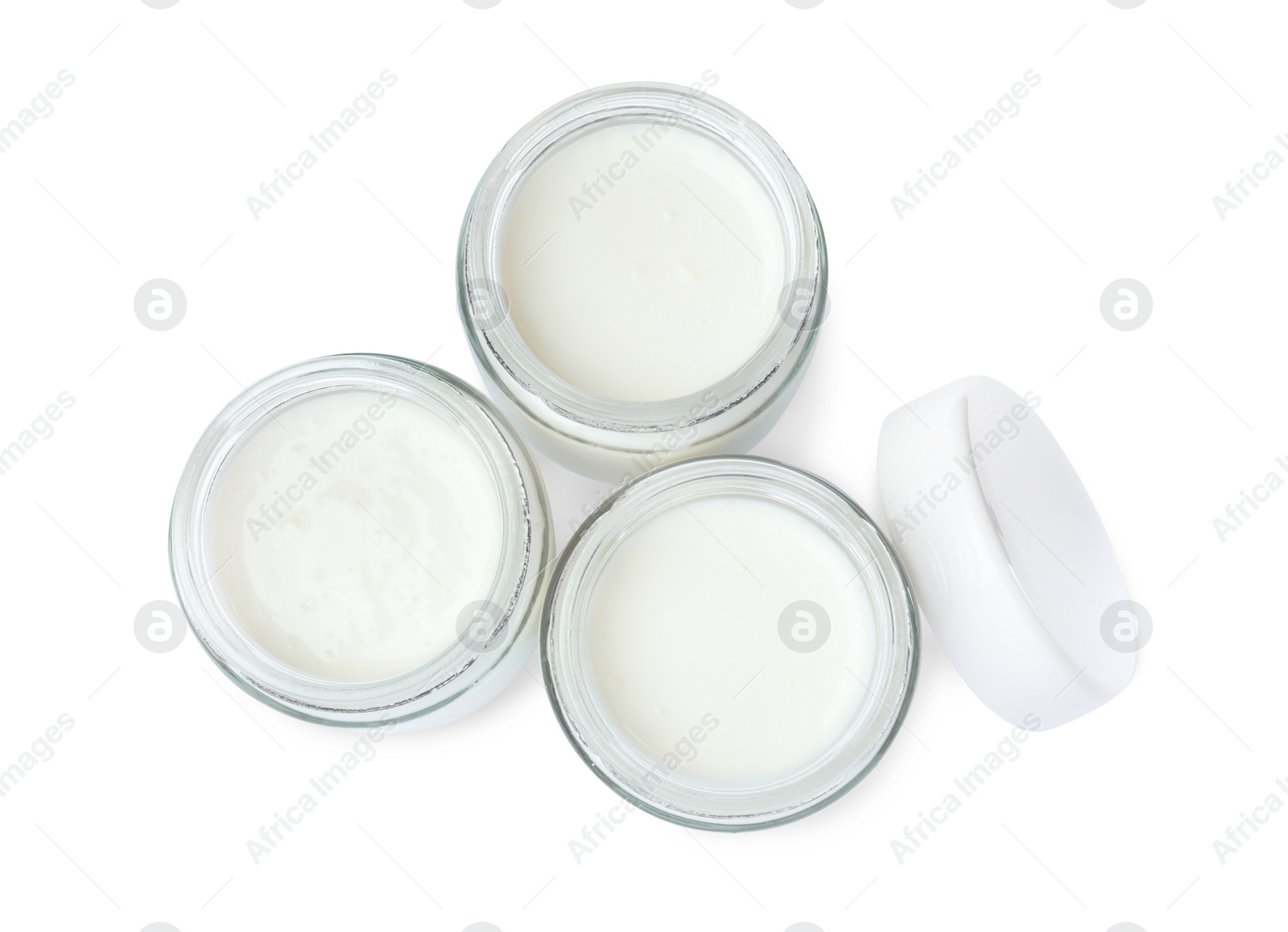 Photo of Glass jars with delicious homemade yogurt on white background, top view