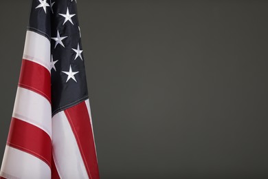 Photo of USA flag on grey background. Space for text