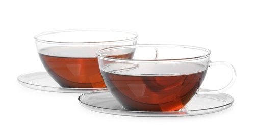 Photo of Glass cups of hot aromatic tea on white background