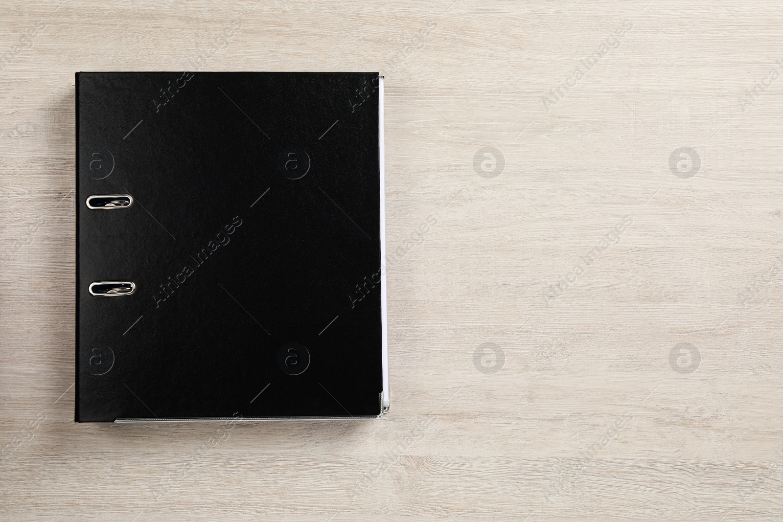 Photo of Black office folder on white wooden table, top view. Space for text