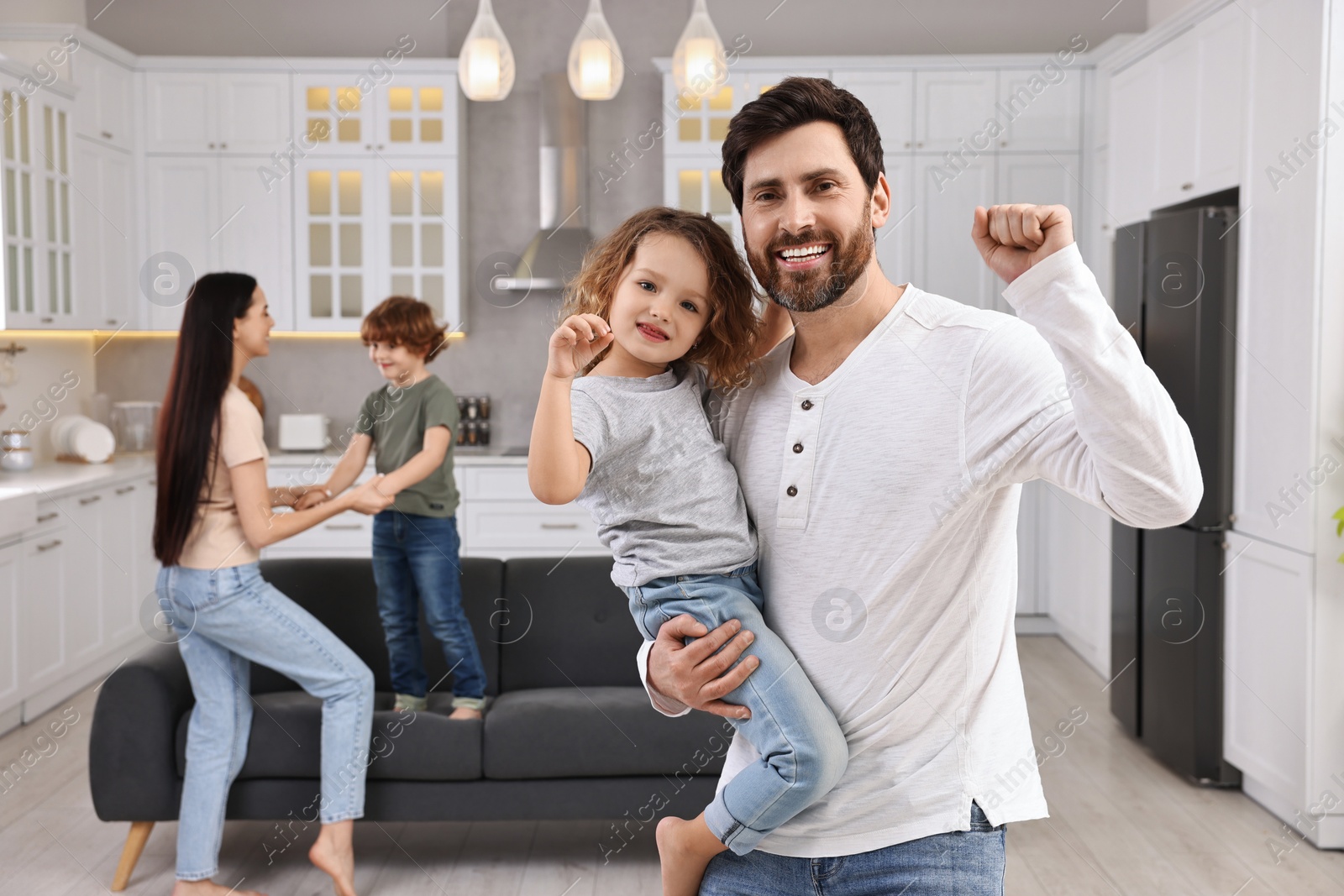 Photo of Happy family dancing and having fun at home