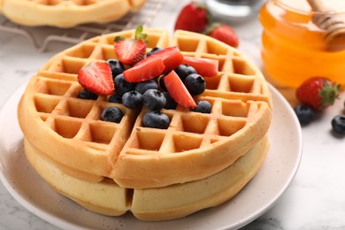 Photo of Tasty Belgian waffles with fresh berries on table, closeup