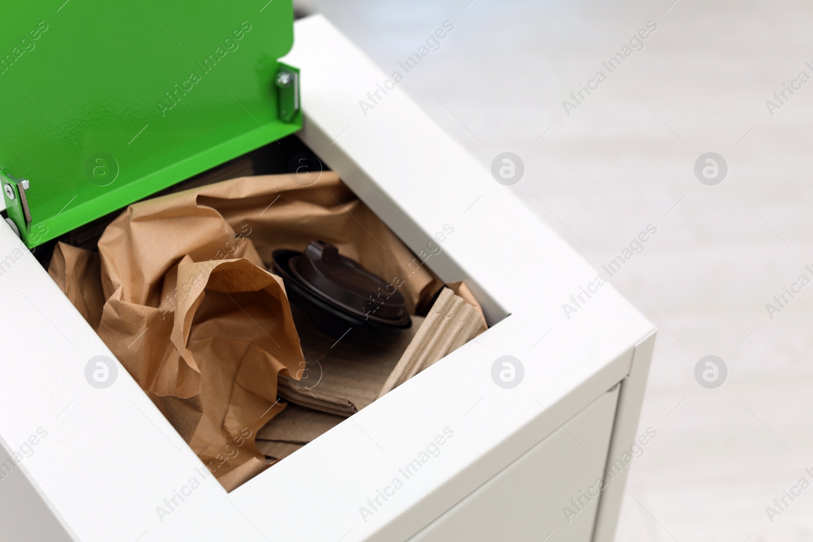 Photo of Open full trash bin on light background, closeup with space for text. Waste recycling
