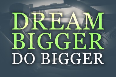 Dream Bigger Do Bigger. Inspirational quote motivating to set life goals freely and forget about reasons that can hold back. Text against luxury car interior