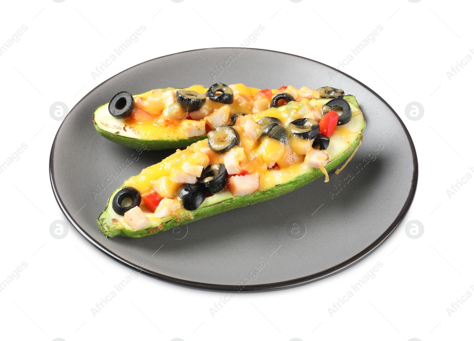 Photo of Plate of baked stuffed zucchinis on white background