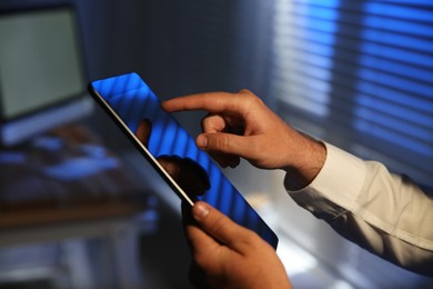 Photo of Businessman using modern tablet in office, closeup